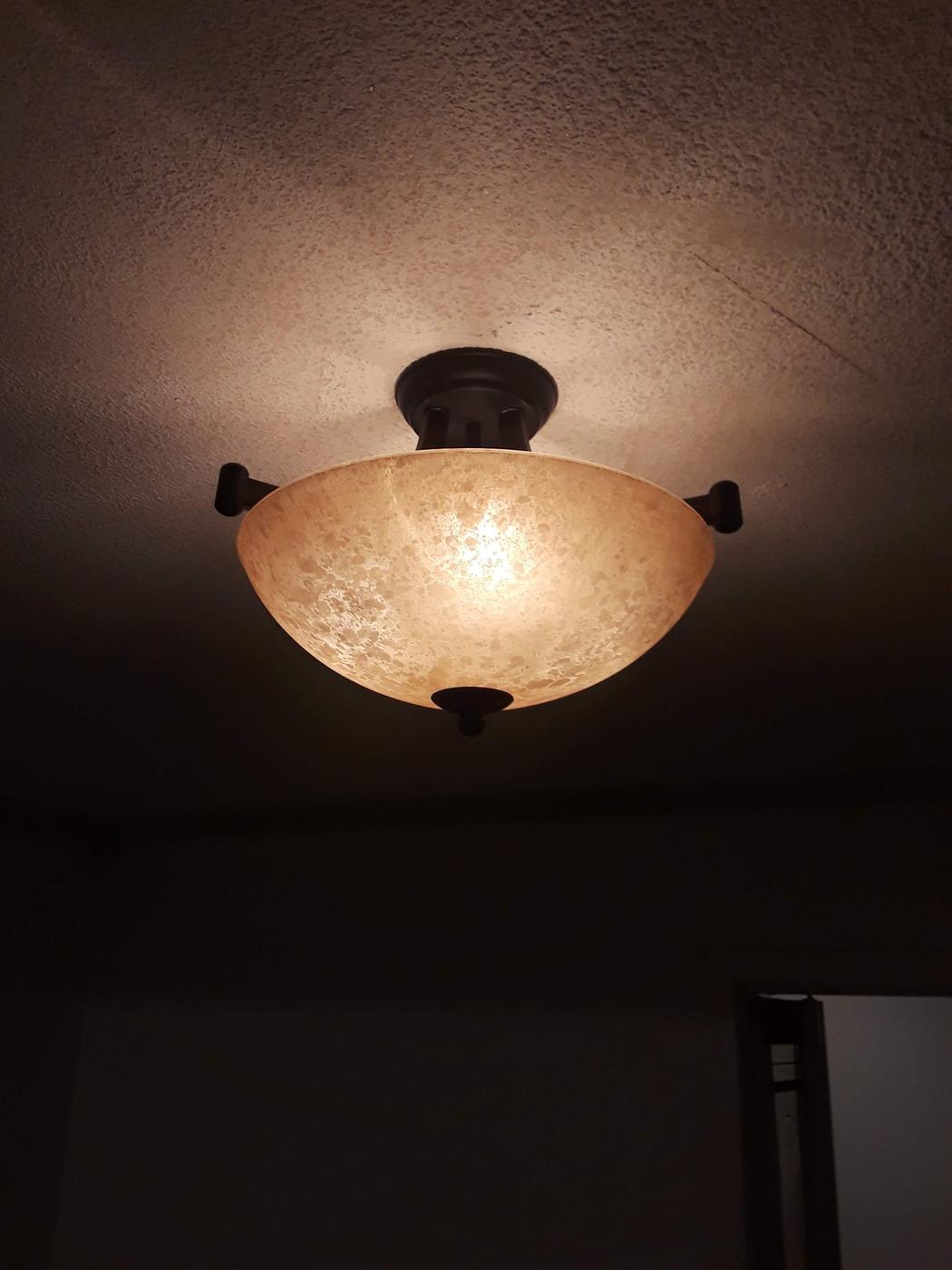 A ceiling light fixture installed and lit